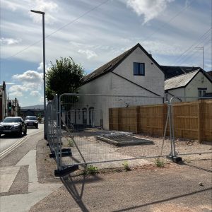 A view of the vacant site of Longforth Road Toilet Block. The site is surrounded with metal fencing.