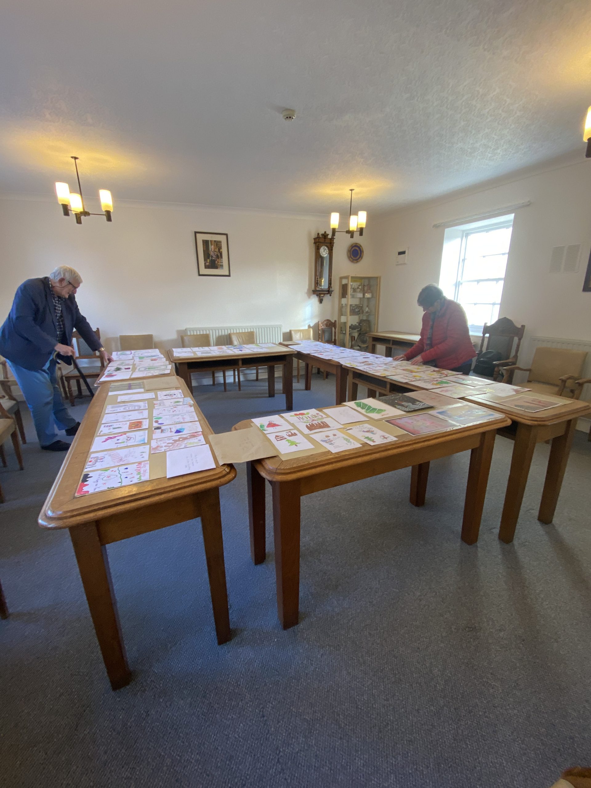 Ian and Janet Lloyd examine the competition entries laid out in the Council Chamber.